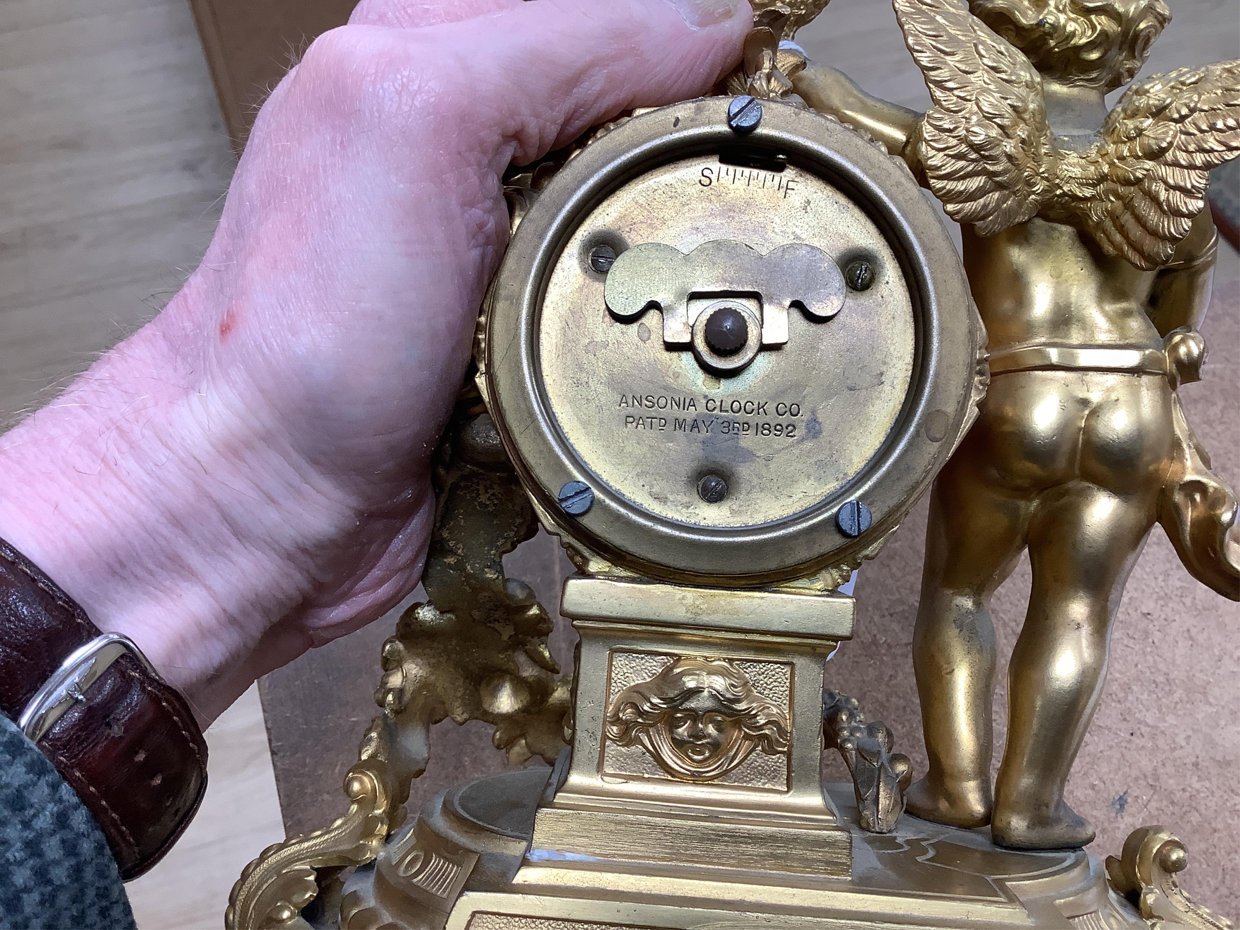 A late 19th century gilt metal cherub timepiece, Ansonia clock company movement, 21cm high